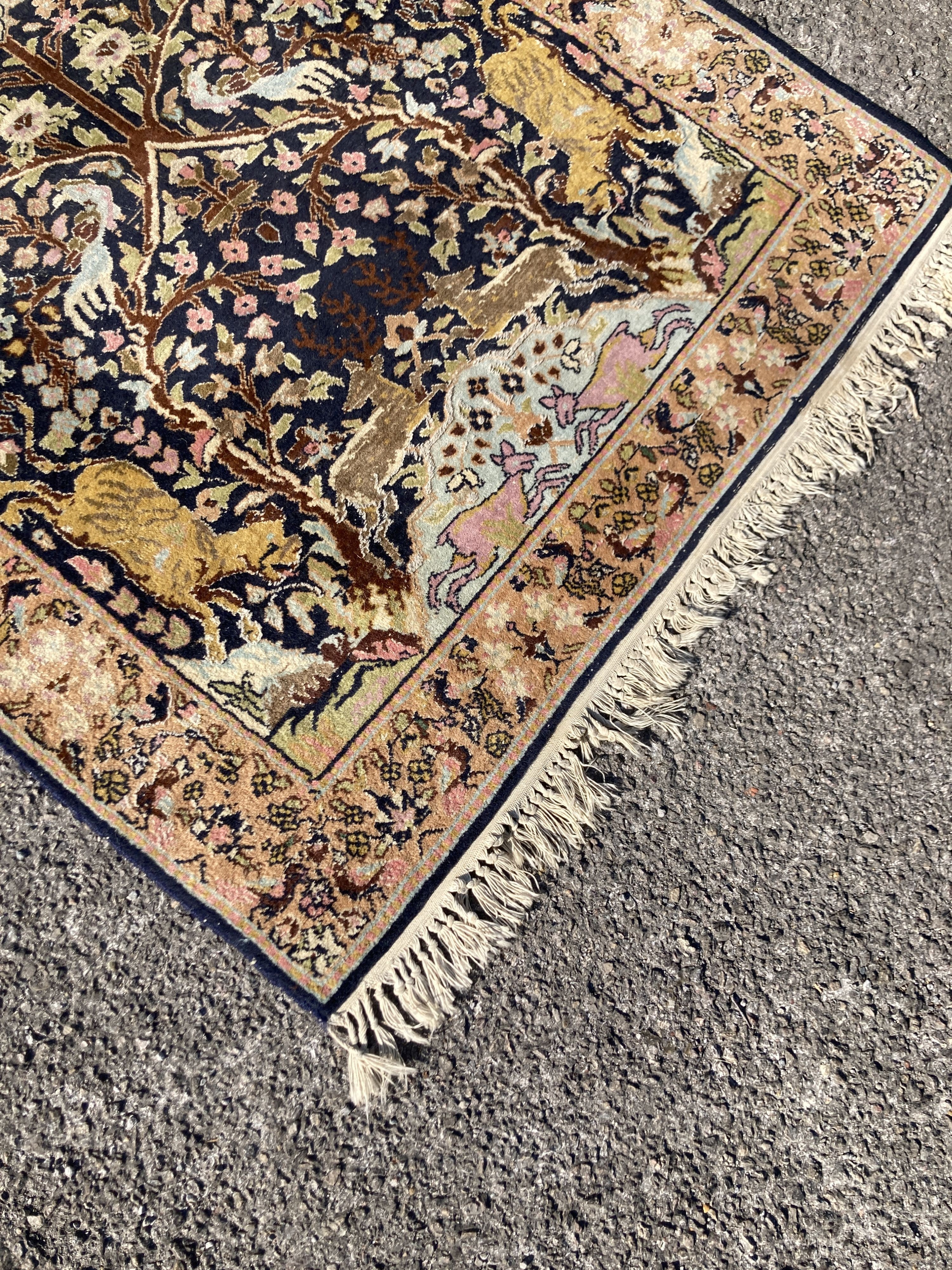 A 19th century Persian rug with Tree of Life field interspersed with animals, 156 x 95cm